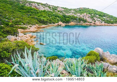 Sardinia costline with sandstone rocks and hidden bay with clear blue sea water. Italy.
