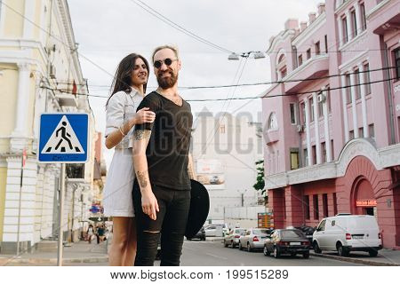 Man And Woman Or Young Couple Making A Trip As Tourists In City.