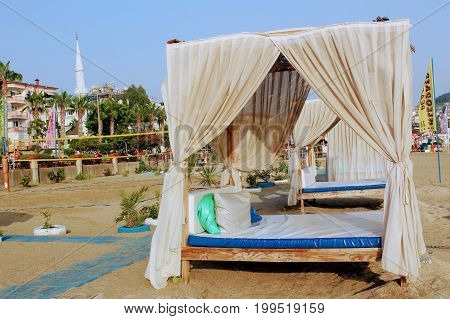 July, 2017 - Bed with canopy on the beach in Alanya, Turkey.
