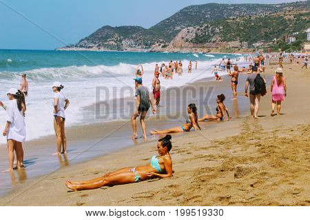 July, 2017 - Vacationers bathe in the sea and sunbathe in the sun on Cleopatra Beach (Alanya, Turkey).