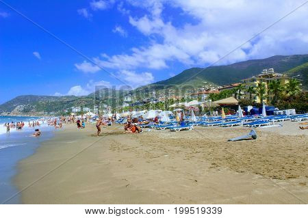 July, 2017 - Vacationers bathe in the sea and sunbathe in the sun on Cleopatra Beach (Alanya, Turkey).