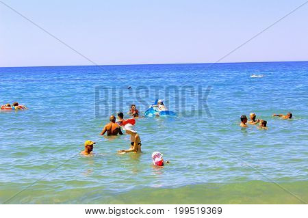 July, 2017 - Vacationers bathe in the sea and sunbathe in the sun on Cleopatra Beach (Alanya, Turkey).