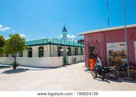 MAAFUSHI MALDIVES - MARCH 02 2016: Horizontal picture of Masjidhul Faarooq Mosque and local market in Maafushi in Maldives.