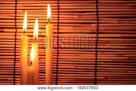 Group Of Candle Light On Blurred Old Wooden Background At The Night. Selective Focus On Tha Candle W
