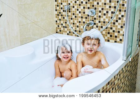 Children taking a bath .Cheerful brother and sister together take water treatments