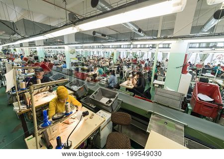 MOSCOW, RUSSIA - FEBRUARY 21, 2017: Moscow shoe factory JSC RALF RINGER . Female and male workers on a sewing machine.