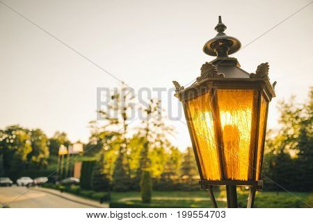 Retro post lamp outside in the evening
