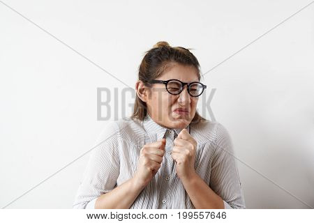 Stressed young European employee or office worker in glasses and shirt screwing her mouth in disgust aversion or antipathy gesturing with hands. Human emotions feelings attitude and reaction