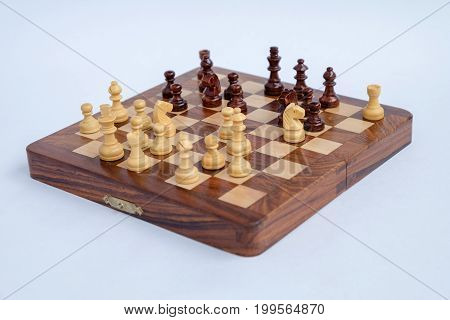 Chessboard with figures in progress isolated over the white background.