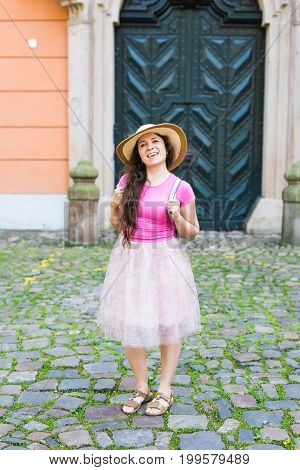 Beautiful young woman posing against the background of an old door.