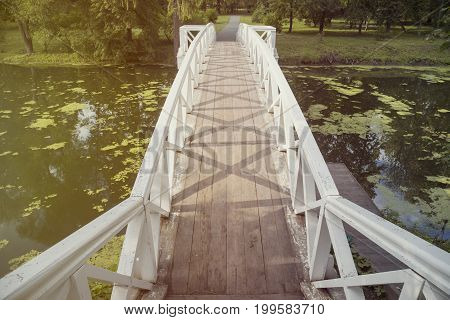 wooden bridge over a small stream in a park