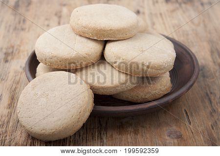 Home barley cookies in a plate on an old wooden table
