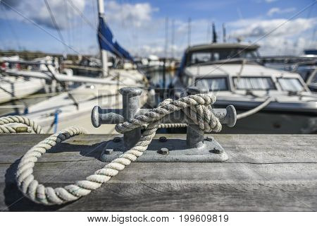 Old harbor mooring in the background of the summer marina on a sunny day.