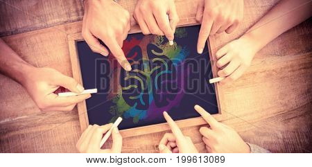 Graphic image of brain on colorful splash against hands writing on chalkboard