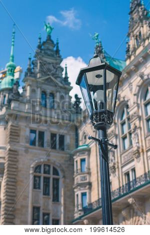 Old lantern in front od Hamburg City Hall Towers. Germany.