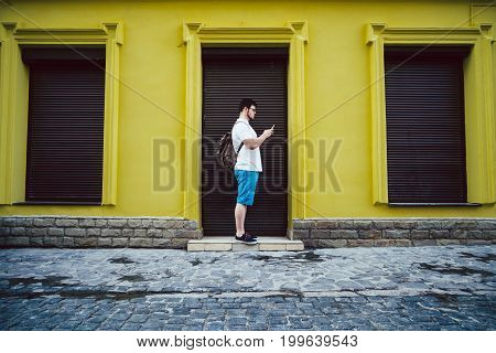 man stand on outside and chatting closed store on background