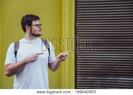 man stand outside and pointing to empty space