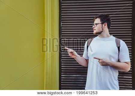 man stand outside and pointing to empty space