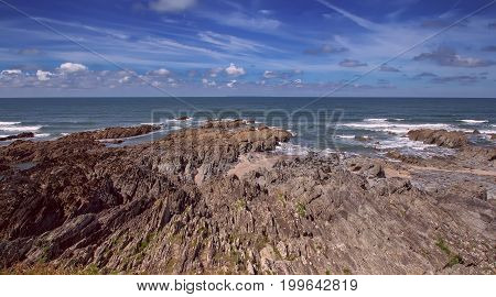 Rocky and dangerous shore next to the beach of Voulakombe. Sunny day. Low tide. Devon. England