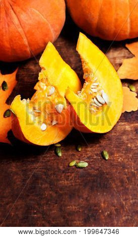Autumn Pumpkin Thanksgiving Background concept - orange pumpkins over wooden table with pieces