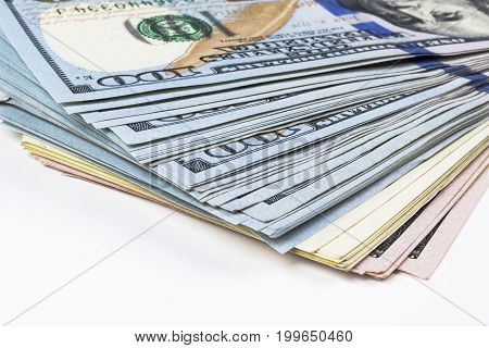 Stack of one hundred dollar bills. Stack of cash money in hundred dollar banknotes. Heap of hundred dollar bills on white background