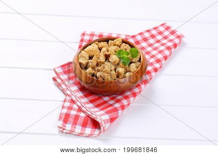 bowl of soy meat cubes on checkered place mat