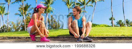 Runners couple tying running shoes to run banner. Runner woman and athlete man lacing shoe laces at park. Healthy lifestyle jogging motivation, happy healthy people. Horizontal landscape crop.