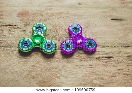 Colored Fidget Spinners Stress Relieving Toy On Wooden Background