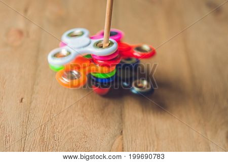Colored Fidget Spinners Stress Relieving Toy On Wooden Background