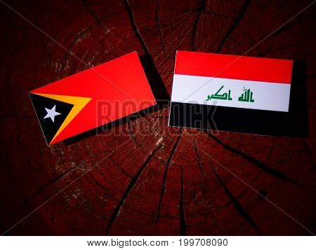 East Timorese Flag With Iraqi Flag On A Tree Stump Isolated