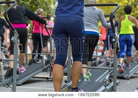 Women In Sportswear Exercising Outdoor On Treadmills