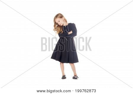 Charming Little Girl In A Black Dress With His Hands Crossed On His Chest. Isolated On White Backgro