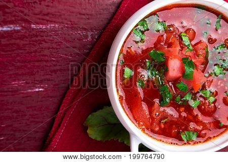 Ukrainian Traditional Borsch. Russian Vegetarian Red Soup  In White Bowl On Red Wooden Background. T