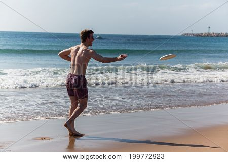 Teenagers Beach Frisby Throwing