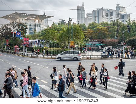 Shanghai, China - Nov 6, 2016: Pedestrians on zebra crossing along Xizang Middle Road. Image captured from a public bus.