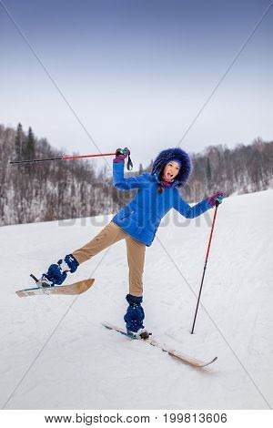 smiling happy young woman skier in winter forest