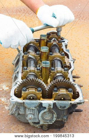 Cylinder head on rusty steel. Vertical image
