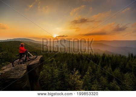 Mountain biking women riding on bike in autumn mountains forest landscape. Woman cycling MTB flow trail track. Outdoor sport activity.