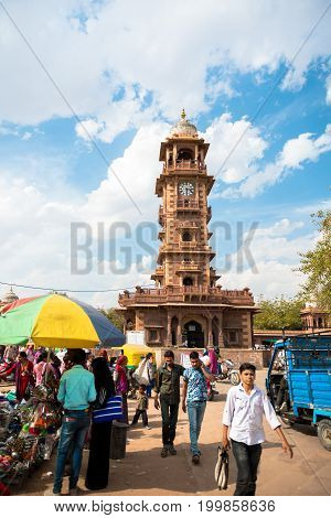 JODHPUR RAJASTHAN INDIA - MARCH 04 2016: People at the Sadar Market. In the back Victorian Clock Tower in Jodhpur the blue city of Rajasthan in India.