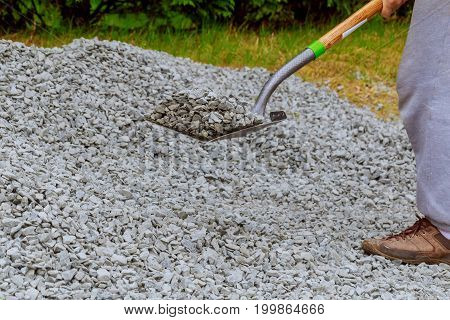 Shovel Throw Stones Into Gabione