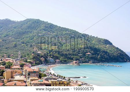 Beautiful daylight view to green mountains, blue sea and buildings of Levanto, Italy. Cinque Terre beauties