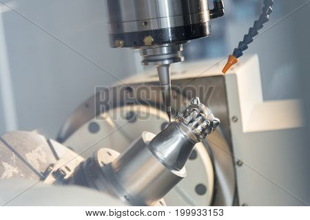 The CNC milling machine cutting the sample part with the small end-mill .Hi-precision CNC machining concept.
