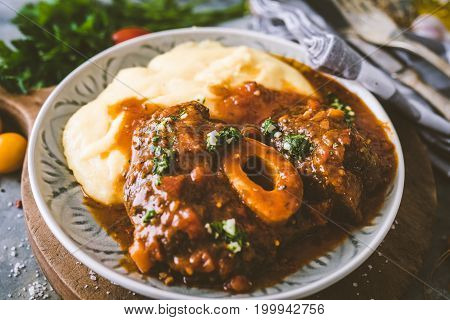 Osso bucco Beef Stew with Polenta on wooden background