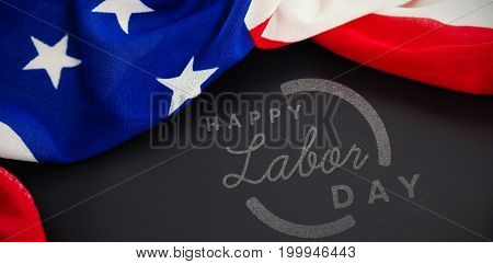 Digital composite image of happy labor day text with blue outline against american flag on blank slate