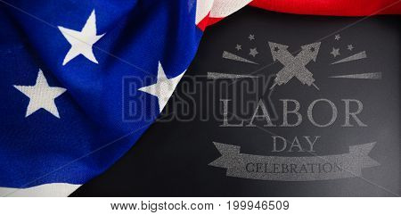Digital composite image of labor day celebration text against american flag on slate