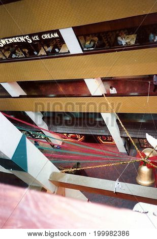 SINGAPORE - CIRCA 1990: A view inside Singapore's Plaza Singapura shopping mall, which is festively decorated for Christmas.