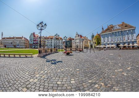 TIMISOARA ROMANIA - AUGUST 16 2017: View of one part at Union Square in Timisoara Romania with old buildings. Trinity Statue and serbian vicariate in foreground.