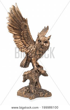 A bronze statuette of a flying owl with flapping wings isolated on white background