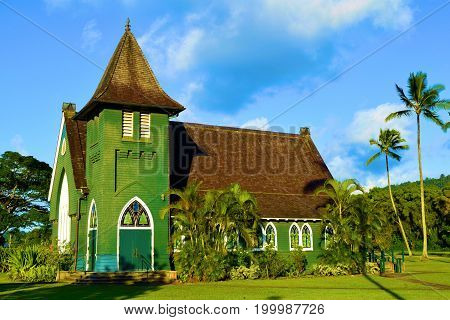 Waioli Huiia Mission Church which was built by missionaries in 1843 surrounded by lush green manicured gardens taken at Hanalei Bay in Kauai, HI