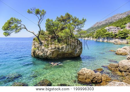 BRELA, CROATIA - 6 JULY, 2017: Paradise Island in the blue Adriatic Sea. Brela, Croatia. Sea coast of Croatia is recognized as one of the cleanest in the world.